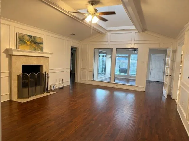 a view of a room with wooden floor and a window