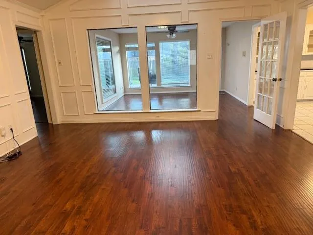 a view of a livingroom with wooden floor and a window