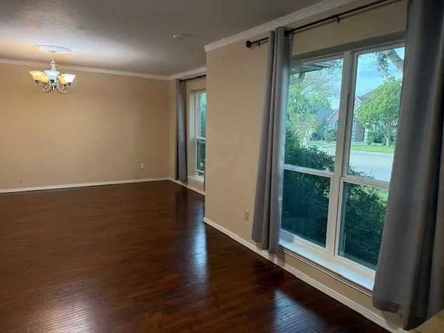 a view of a room with wooden floor and window