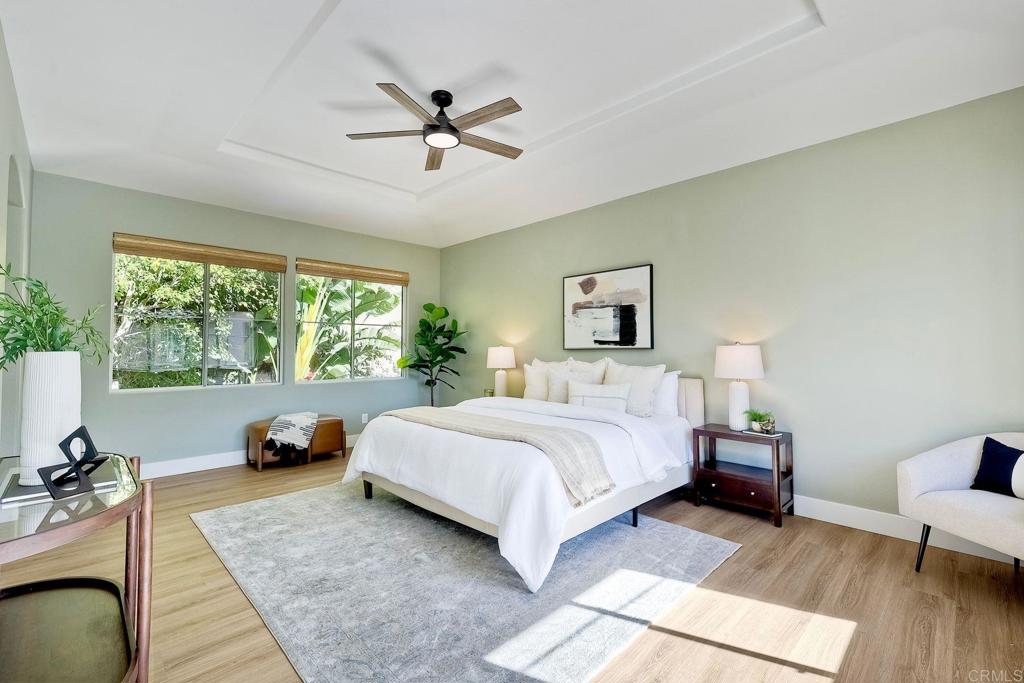 7165 Willet Circle Carlsbad, CA 92011 - Photo 20 of 65 a spacious bedroom with a bed a couch and a large window