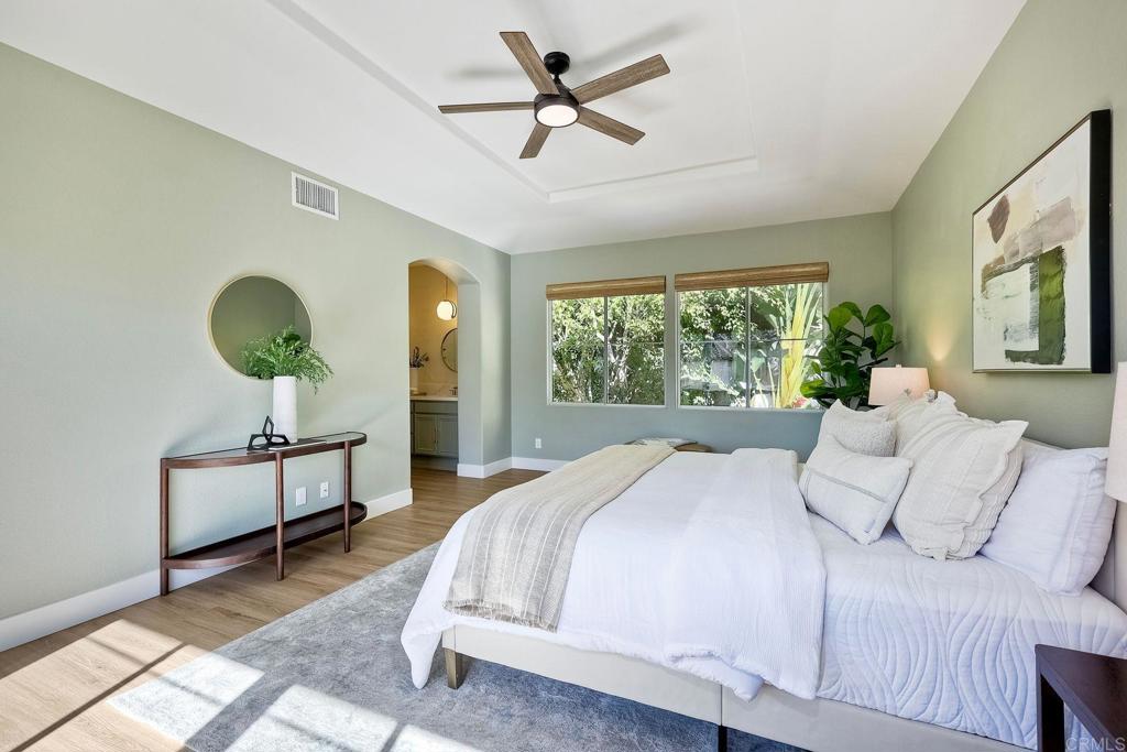 7165 Willet Circle Carlsbad, CA 92011 - Photo 23 of 65 a bedroom with a large bed and a chandelier