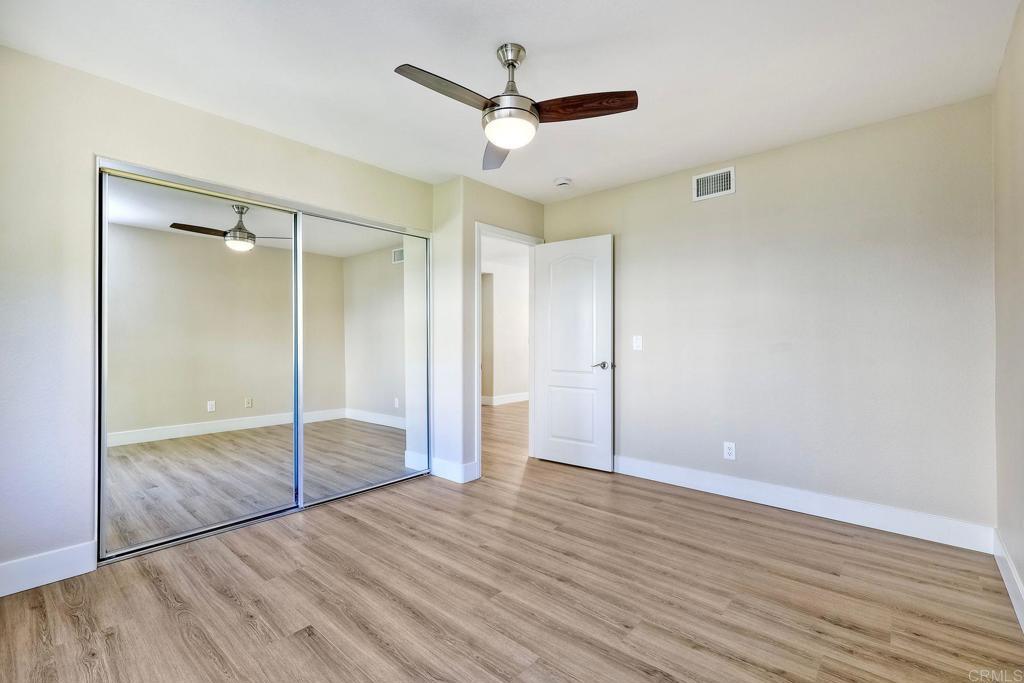 7165 Willet Circle Carlsbad, CA 92011 - Photo 31 of 65 a view of a big room with wooden floor and a ceiling fan