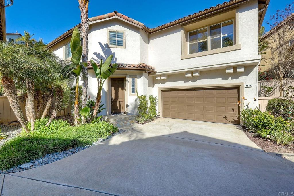 7165 Willet Circle Carlsbad, CA 92011 - Photo 58 of 65 a front view of a house with a yard and garage