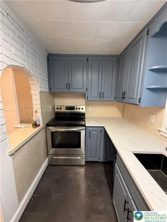a kitchen with a sink and a stove top oven