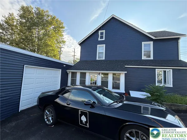 a front view of a house with parking area
