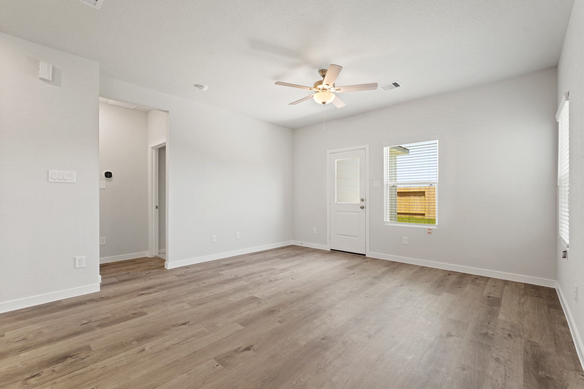 17202 King Eider Road Waller, TX 77484 - Photo 6 of 29 an empty room with a window and wooden floor
