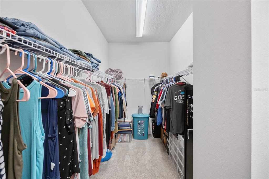 11720 Chevelon Lane Parrish, FL 34219 - Photo 14 of 70 a view of walk in closet with clothes and shoes