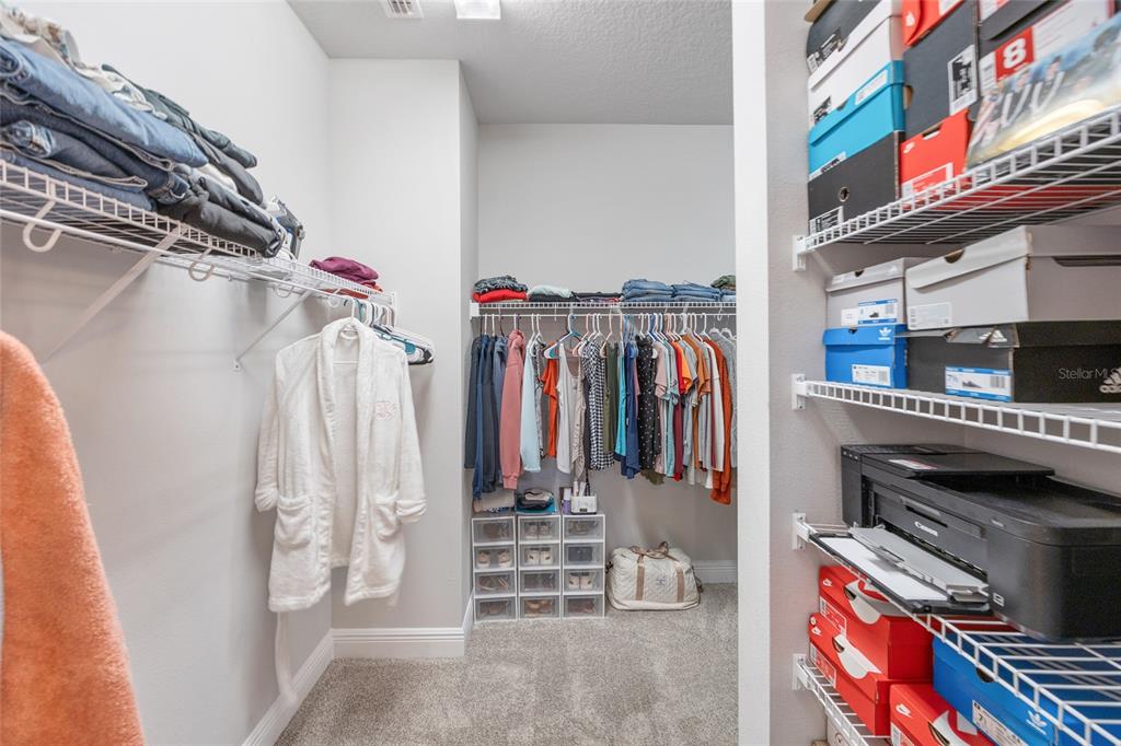 11720 Chevelon Lane Parrish, FL 34219 - Photo 15 of 70 a view of walk in closet with clothes and shoes