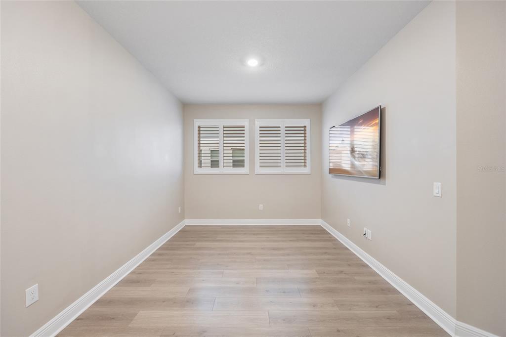 11720 Chevelon Lane Parrish, FL 34219 - Photo 17 of 70 an empty room with wooden floor and windows