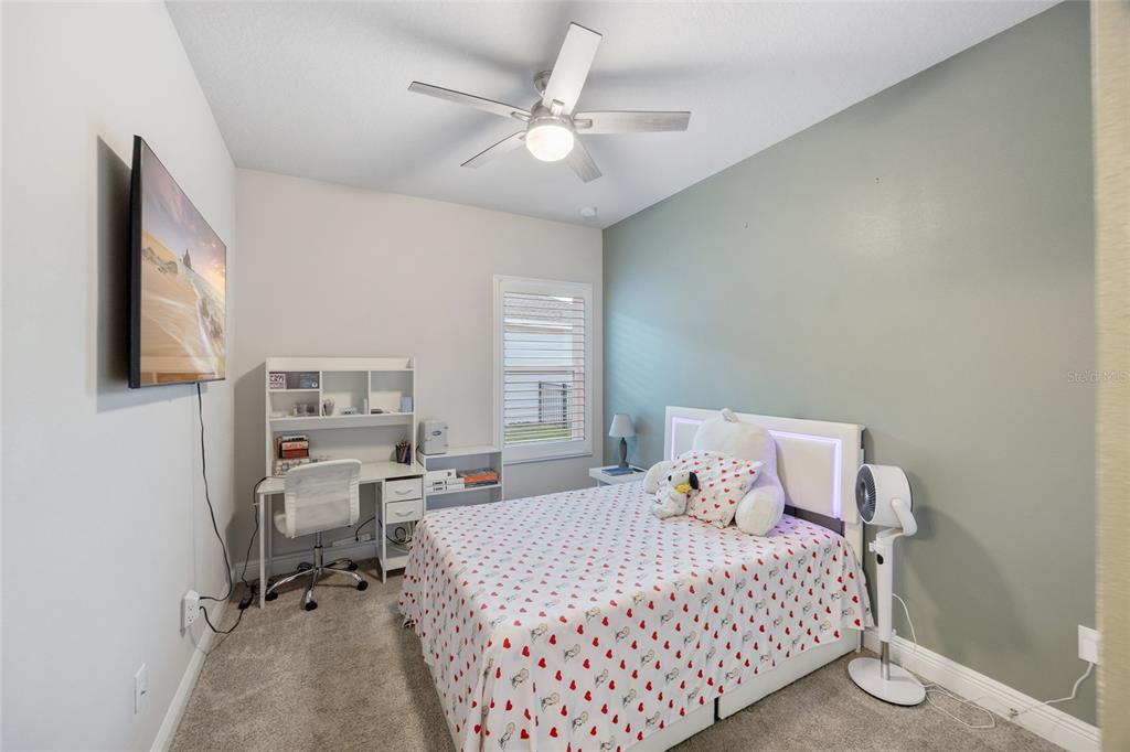 11720 Chevelon Lane Parrish, FL 34219 - Photo 18 of 70 a bedroom with a bed and a flat screen tv