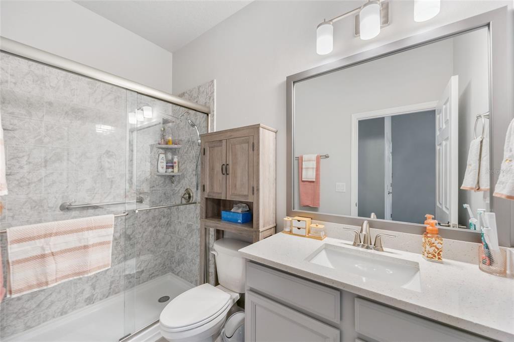 11720 Chevelon Lane Parrish, FL 34219 - Photo 19 of 70 a bathroom with a sink a toilet and shower