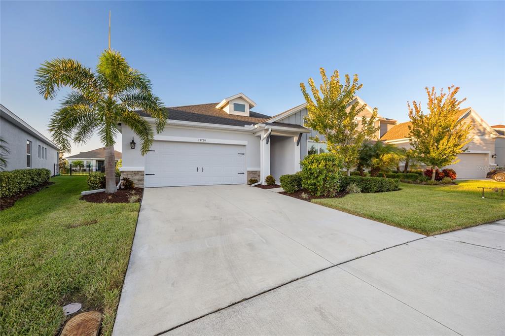 11720 Chevelon Lane Parrish, FL 34219 - Photo 32 of 70 a front view of house with yard and green space
