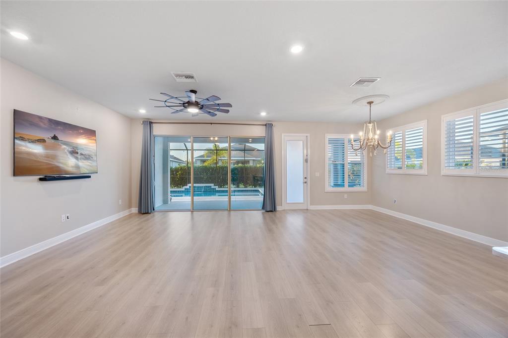 11720 Chevelon Lane Parrish, FL 34219 - Photo 4 of 70 a view of an empty room with a window and wooden floor