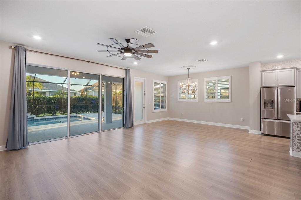 11720 Chevelon Lane Parrish, FL 34219 - Photo 6 of 70 a view of an empty room with a window and wooden floor