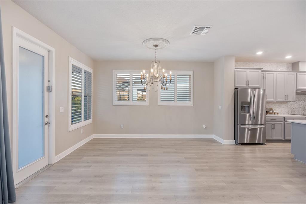 11720 Chevelon Lane Parrish, FL 34219 - Photo 7 of 70 a view of large kitchen with a sink refrigerator and wooden floor