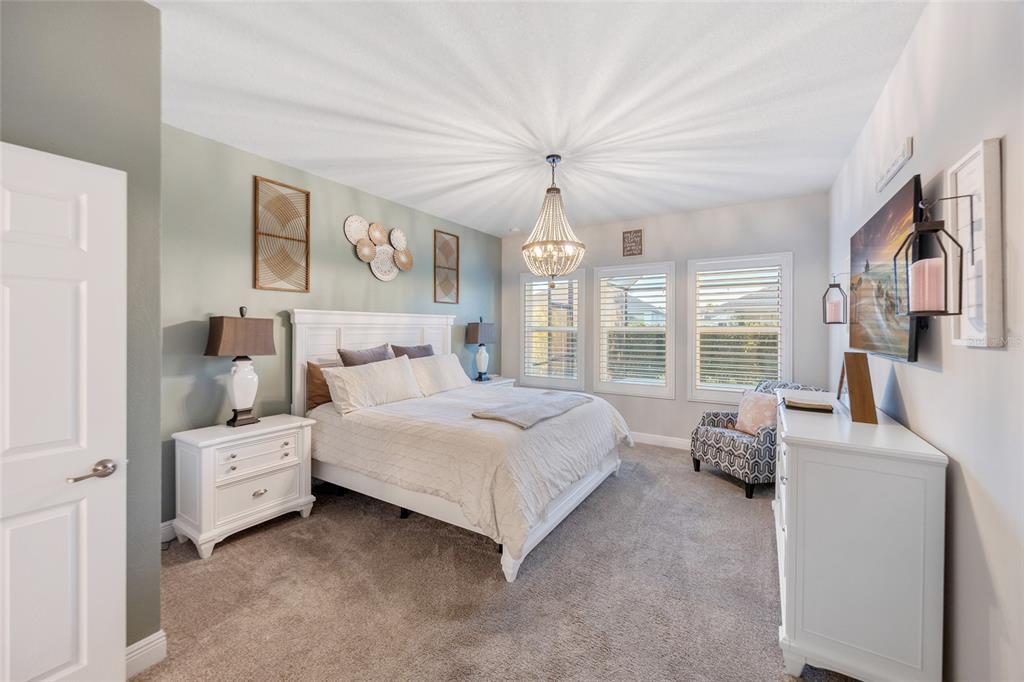 11720 Chevelon Lane Parrish, FL 34219 - Photo 10 of 70 a spacious bedroom with a bed and a large window