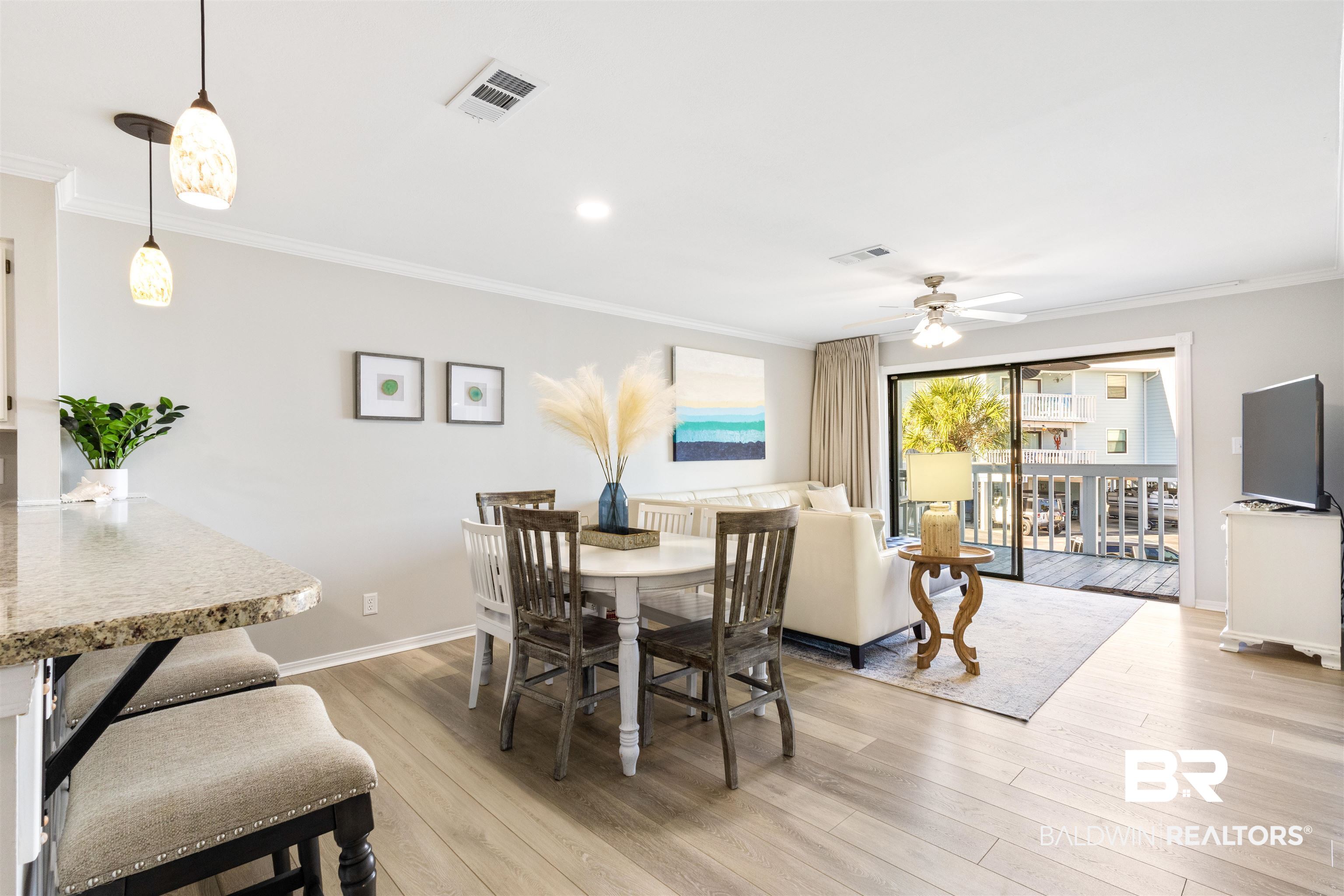 25861 Canal Road, Unit 3 Orange Beach, AL 36561 - Photo 9 of 40 Dining area with ornamental molding, light wood-style floors, and a ceiling fan