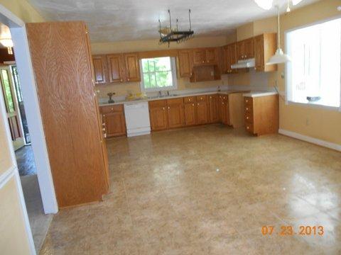 7737 Pinewood Road Primm Springs, TN 38476 - Photo 11 of 13 a kitchen with stainless steel appliances a sink a refrigerator a window and cabinets