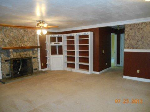 7737 Pinewood Road Primm Springs, TN 38476 - Photo 6 of 13 a view of an empty room with a fireplace and a window