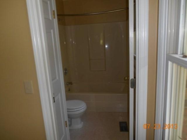 7737 Pinewood Road Primm Springs, TN 38476 - Photo 8 of 13 a bathroom with a granite countertop shower and a toilet