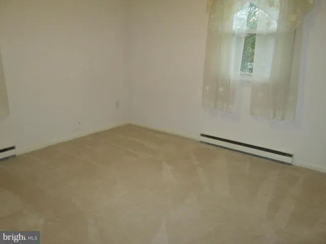 a view of an empty room with a fireplace