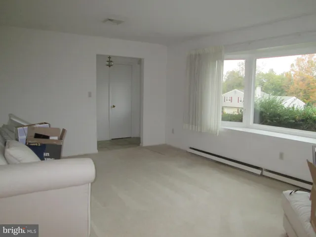 a bedroom with a balcony a bed and a window