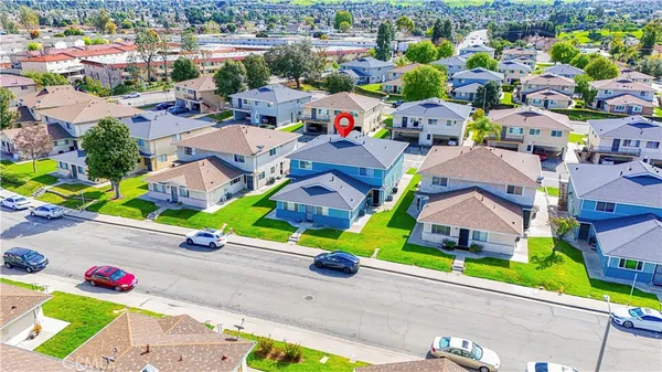 an aerial view of a house with a garden and mountain view in back