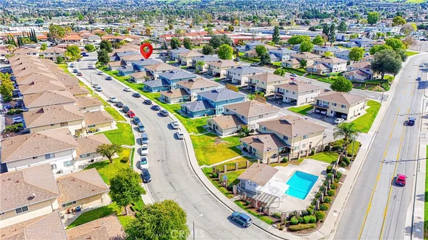 an aerial view of residential houses with outdoor space