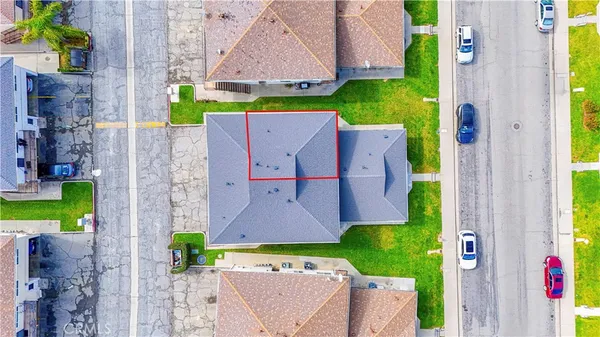 an aerial view of a house with a garden and swimming pool