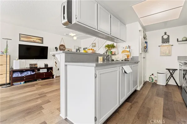 a kitchen with sink cabinets and wooden floor