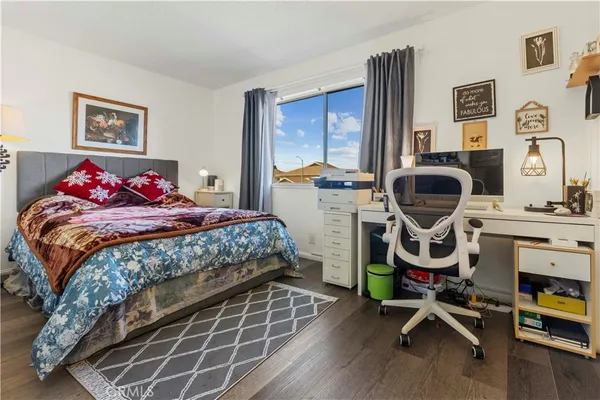 a bedroom with bed and a window