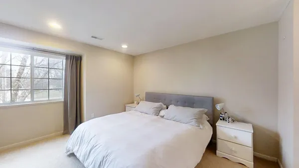 a bedroom with a bed and a window