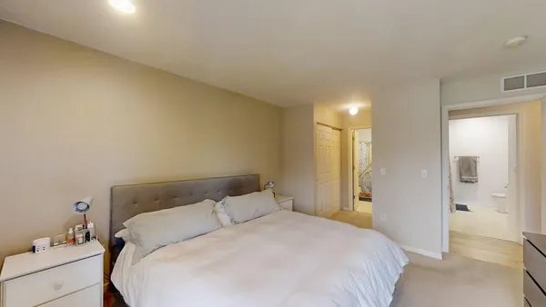 a bedroom with a bed and a mirror