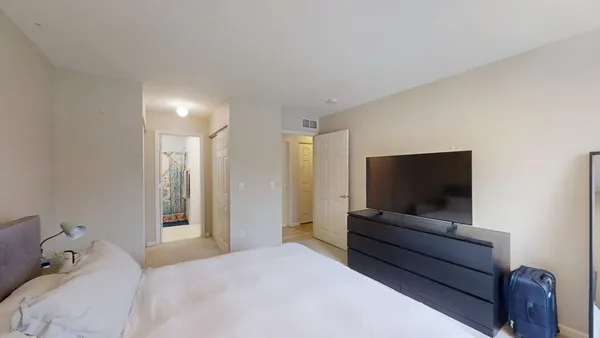 a bedroom with a bed and a flat screen tv