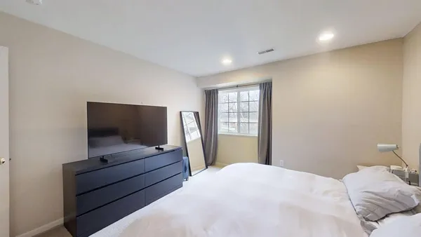a bedroom with bed and tv