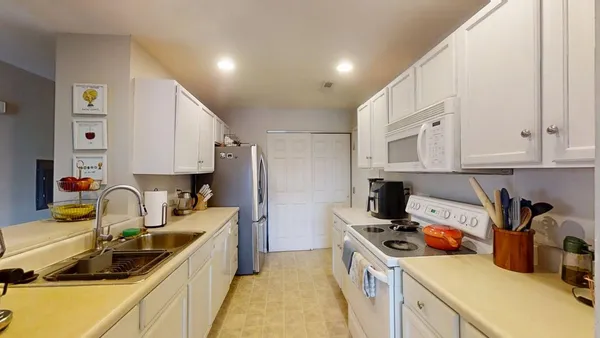 a kitchen with a sink a stove and cabinets