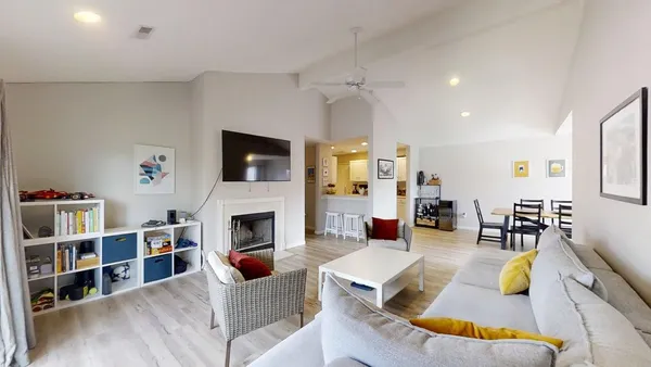 a living room with furniture hard wood floor and a fireplace