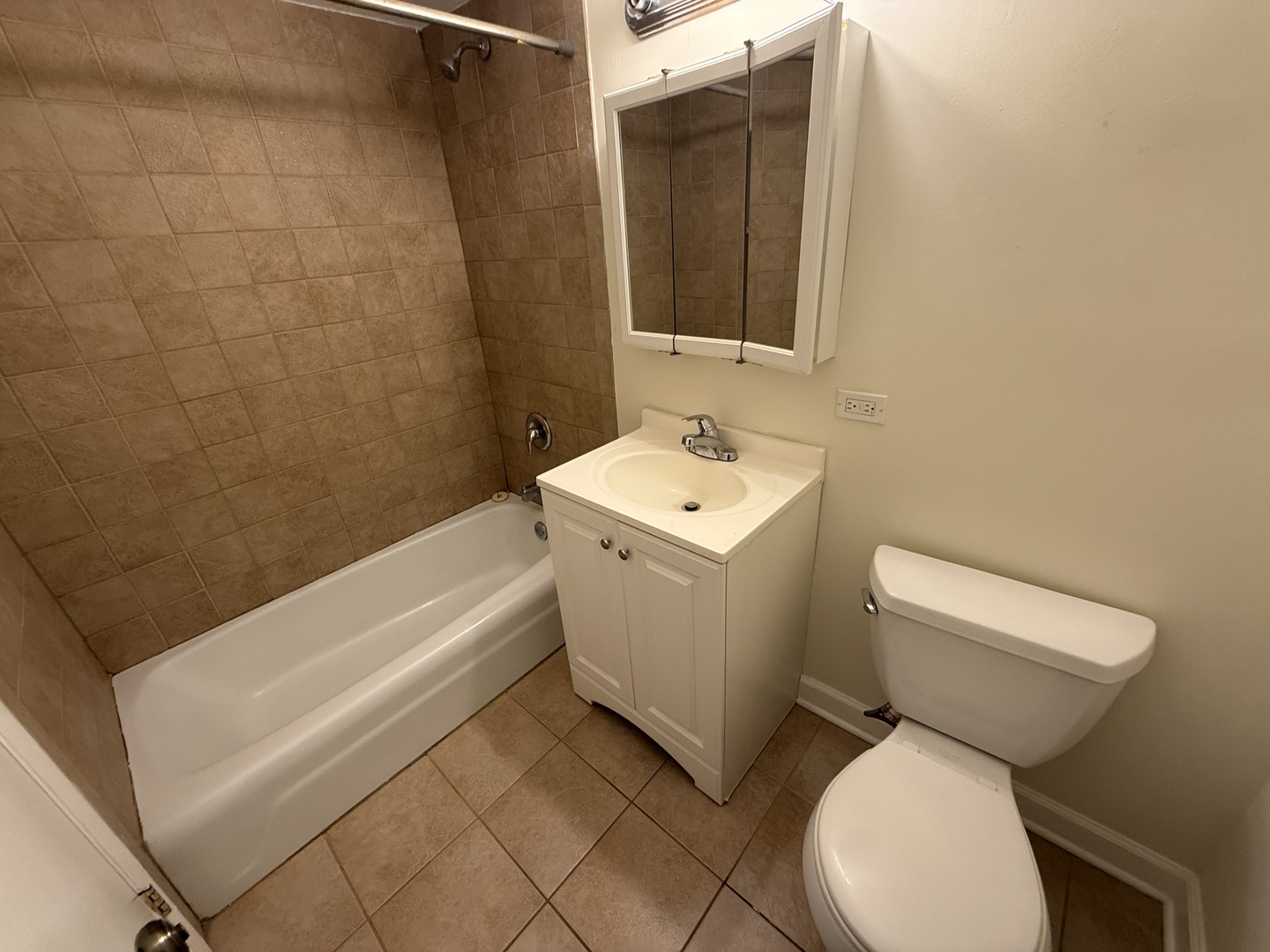 1039 College Avenue, Unit 10E Wheaton, IL 60187 - Photo 15 of 16 a bathroom with a toilet sink and mirror