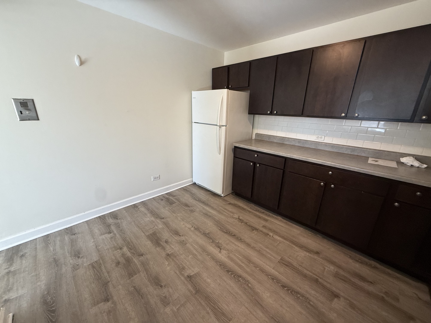 1039 College Avenue, Unit 10E Wheaton, IL 60187 - Photo 9 of 16 a kitchen with a sink and a refrigerator