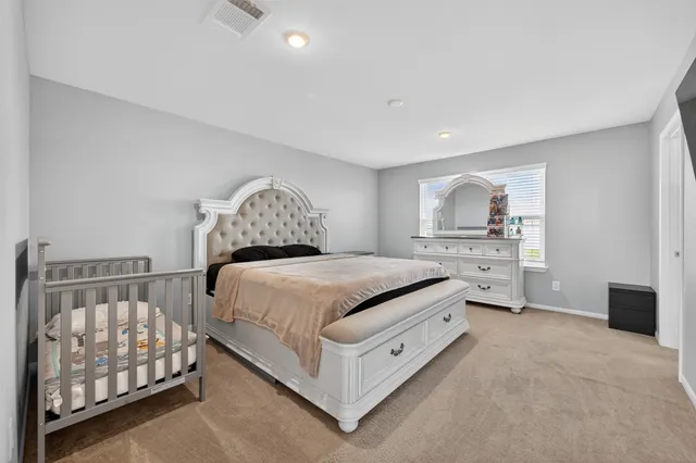 a bedroom with a bed and a lamp on table