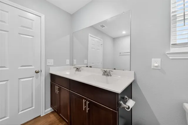 a kitchen with a sink and a mirror