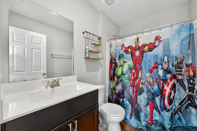 a bathroom with a sink toilet and shower