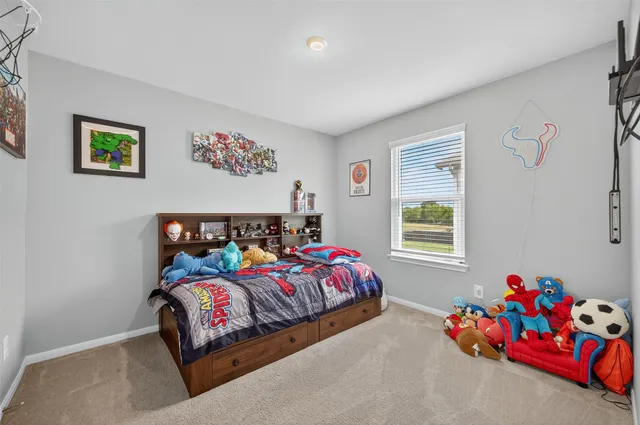 a bedroom with bed and a window