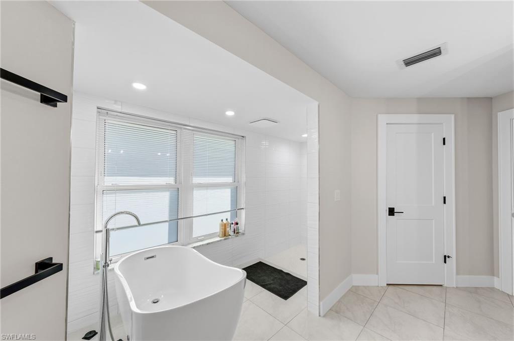 4724 Riverside Drive Estero, FL 33928 - Photo 18 of 44 a bathroom with a tub and a shower