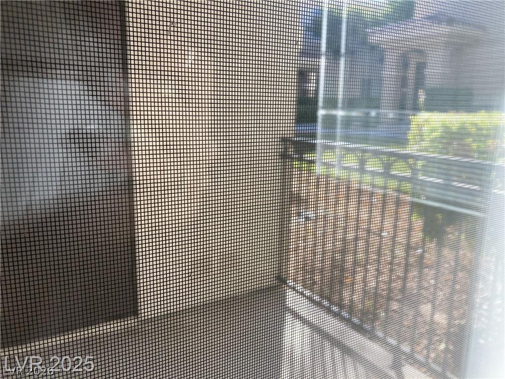 9050 West Warm Springs Road, Unit 1027 Las Vegas, NV 89148 - Photo 11 of 44 A screened patio offers a tranquil outdoor escape with a glimpse of the neighborhood beyond.