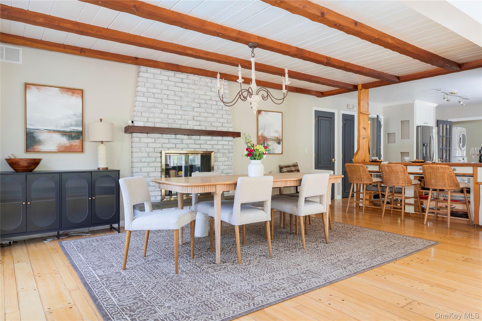 135 Turk Hill Road Brewster, NY 10509 - Photo 12 of 42 a dining room with wooden floor a large window and a rug