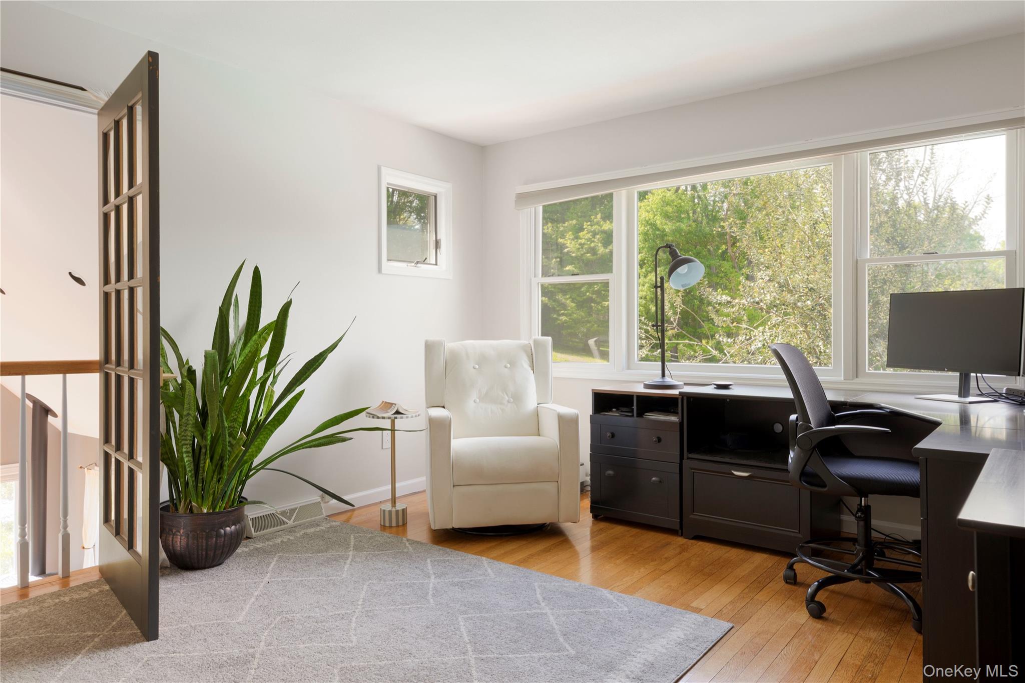 135 Turk Hill Road Brewster, NY 10509 - Photo 28 of 42 a living room with furniture a large window and a potted plant