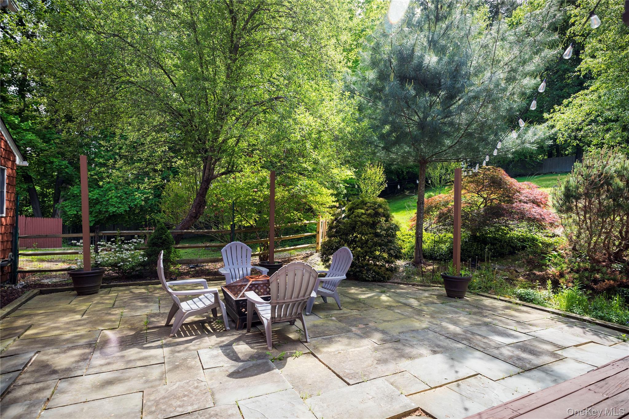 135 Turk Hill Road Brewster, NY 10509 - Photo 31 of 42 a view of a patio with table and chairs and potted plants and large trees
