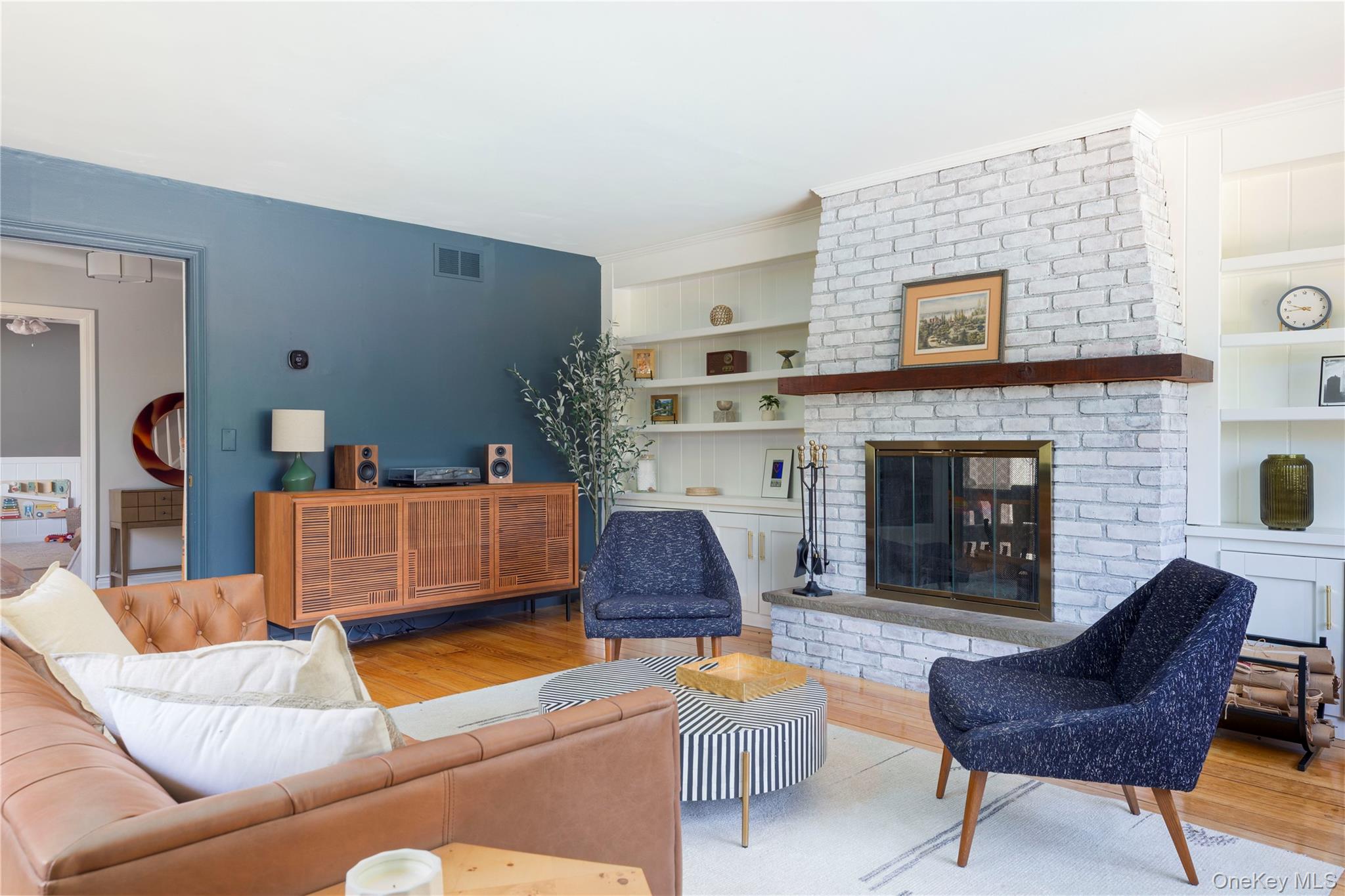 135 Turk Hill Road Brewster, NY 10509 - Photo 7 of 42 a living room with furniture and a fireplace
