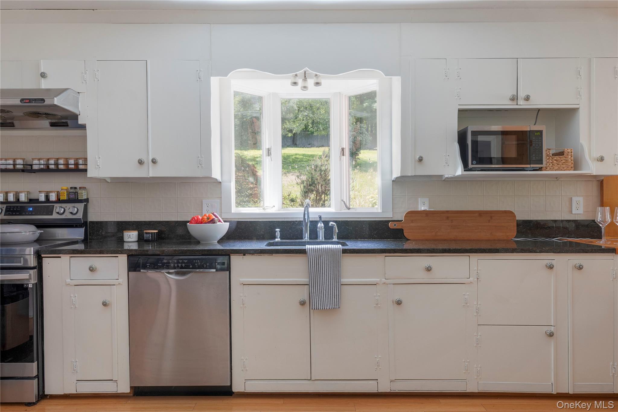 135 Turk Hill Road Brewster, NY 10509 - Photo 9 of 42 a kitchen with granite countertop white cabinets and a sink